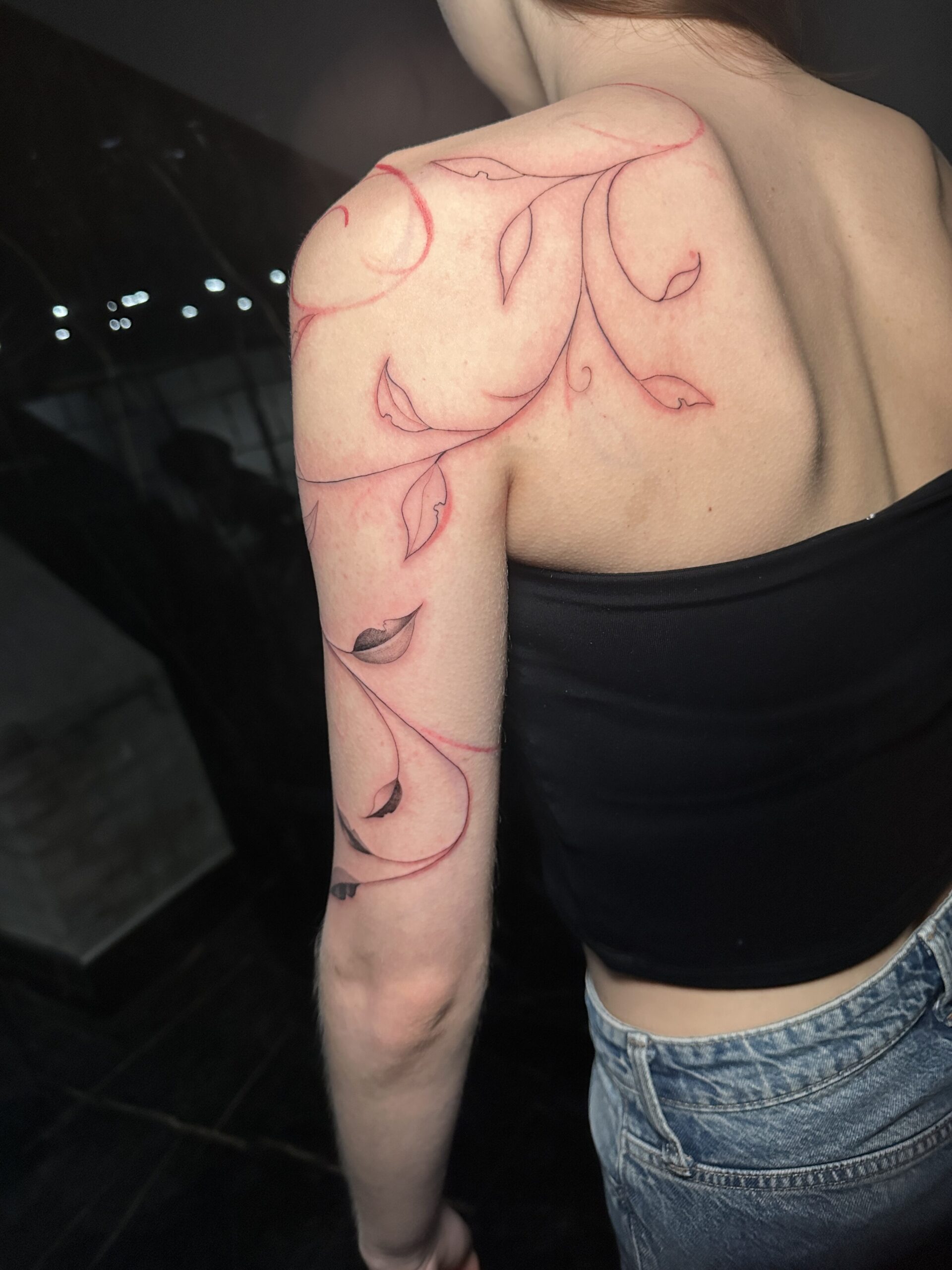 Floral tattoo in black and grey